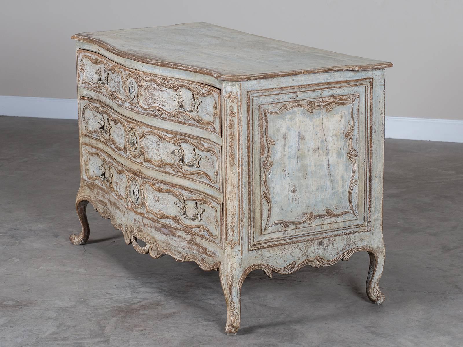 The exceptional carved detail of this Louis XV period chest of drawers, circa 1750 is wonderful to view. Enhanced by the painted finish this chest was designed to be seen from both sides and the front as the exquisite and delicate balance of the