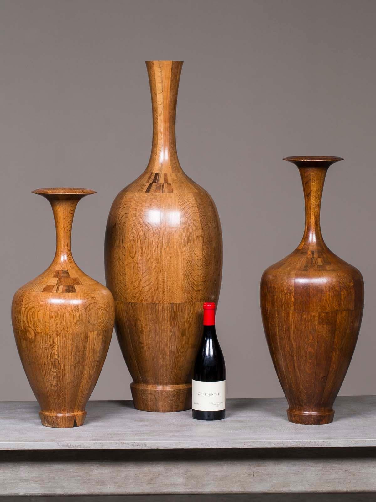 The striking modern quality of these three wood Art Deco vases made of specimen timber from Belgium circa 1940 and their superb craftsmanship lead to their attribution to the famed workshop of De Coene Frères in Kortrijk, Belgium. Please take the