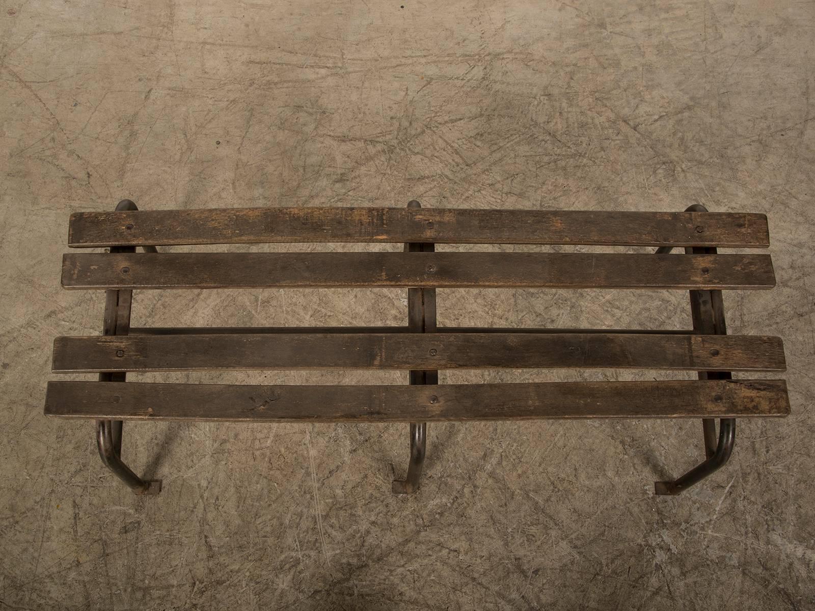 Be the first to see our new arrivals directly through 1stdibs! Please click follow dealer below. 

A simple iron and wood French garden bench, circa 1930 having tubular legs and slatted wood supports in a pleasing weathered finish. With the