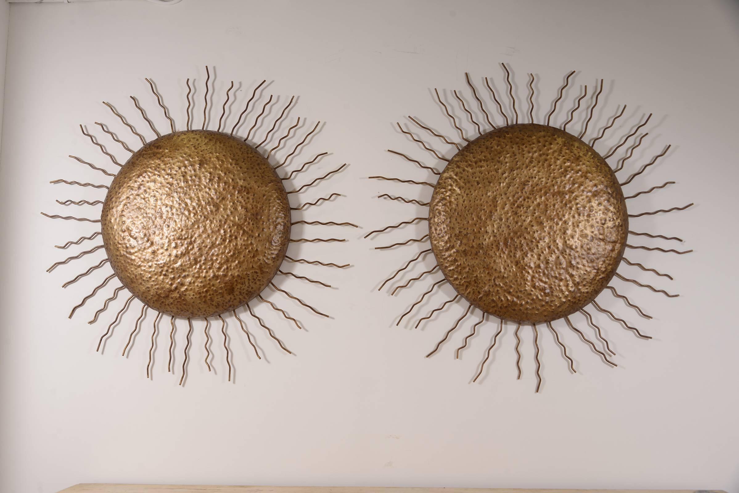 Very chic and large pair of decorative Italian tole suns. Can be sold individually.