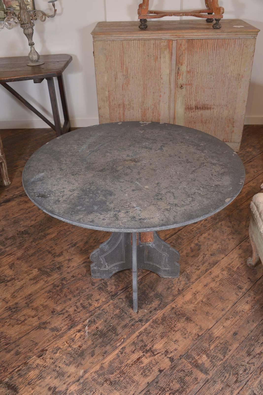 Fabulous round slate table, c 1900. Nice detail on the leg, has an old repair which we think makes it more charming! 