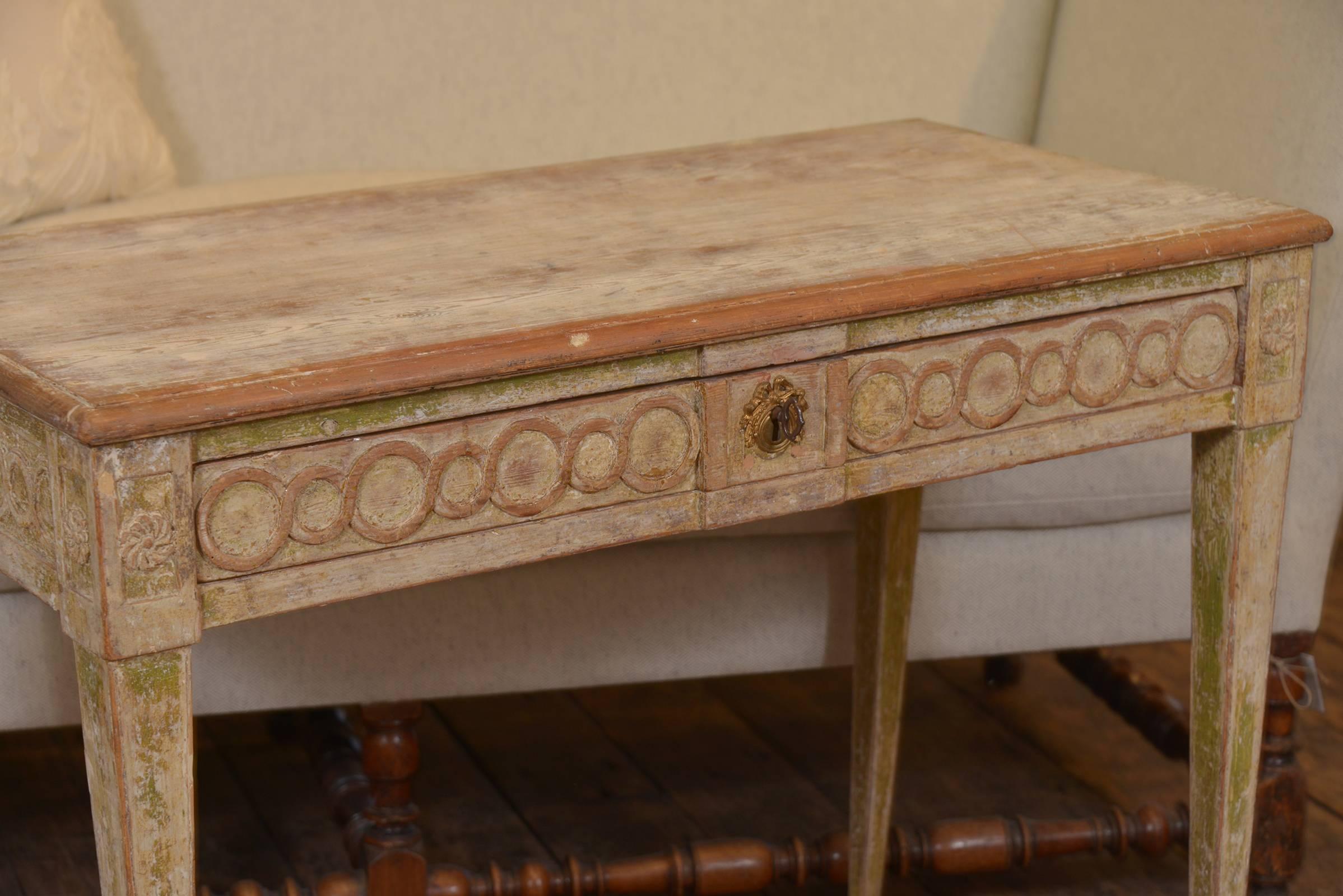 Simple but elegant Swedish Gustavian console in original paint, intricate carving and graceful legs. One single drawer.