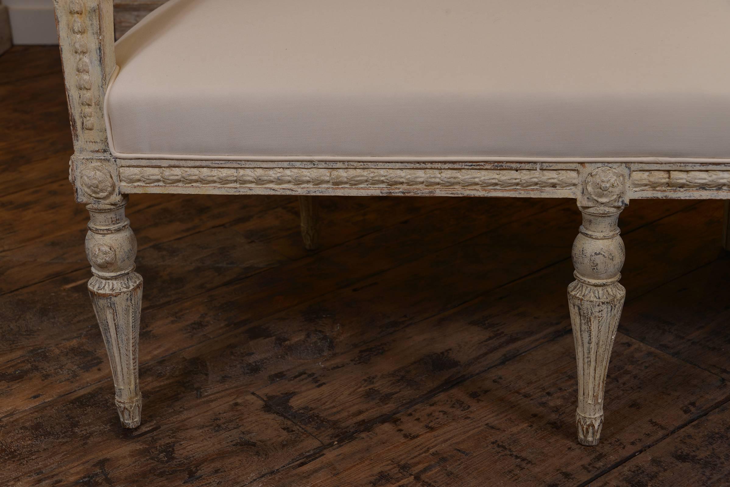 Swedish Gustavian bench circa 1810 upholstered in Holland and Sherry wool, scraped paint finish. A special piece that could float in the room, as the back is as beautiful as the front.