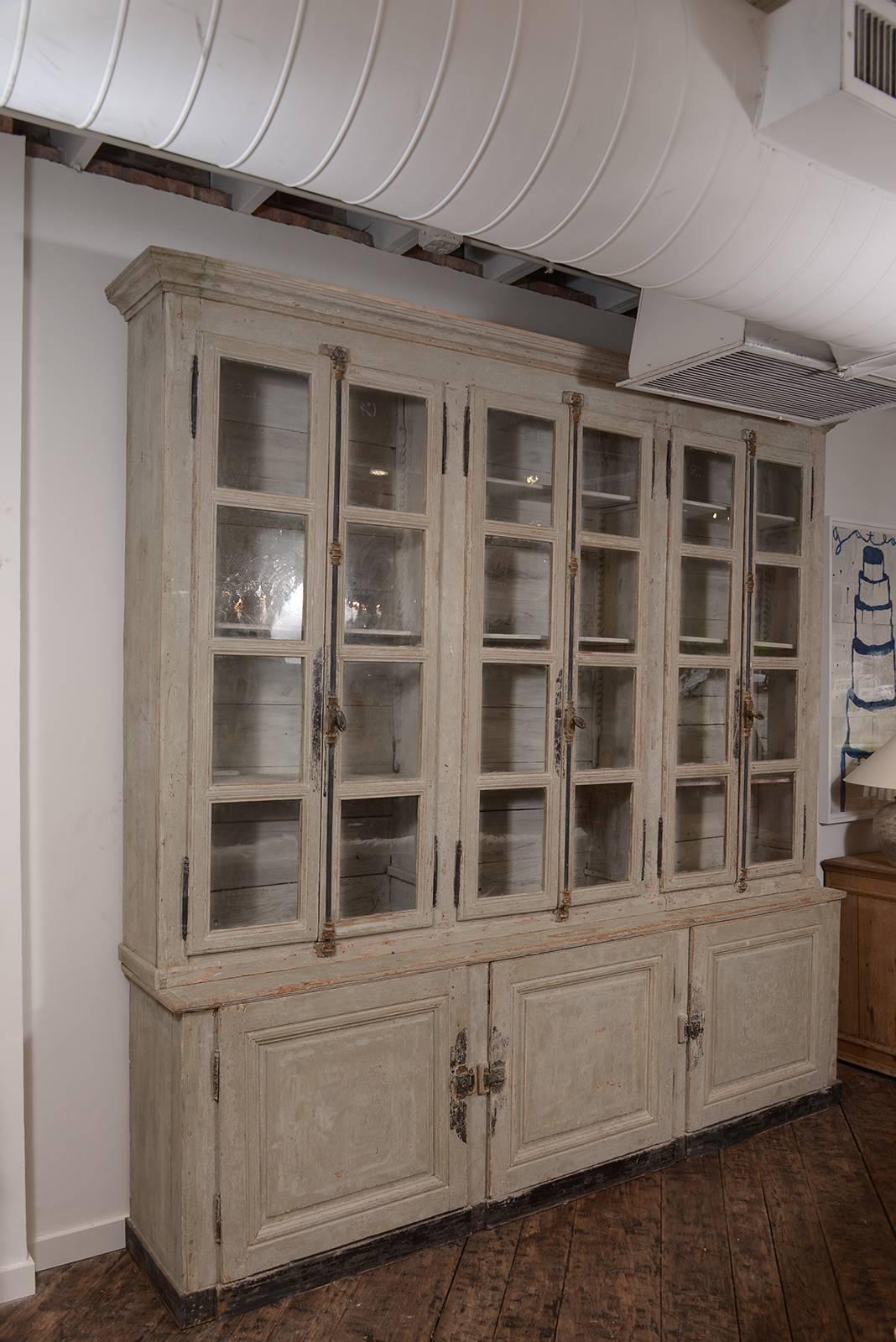 Fabulous and large scale French painted vitrine with original glass and painted finish scraped to the original paint. An exquisite cabinet!
