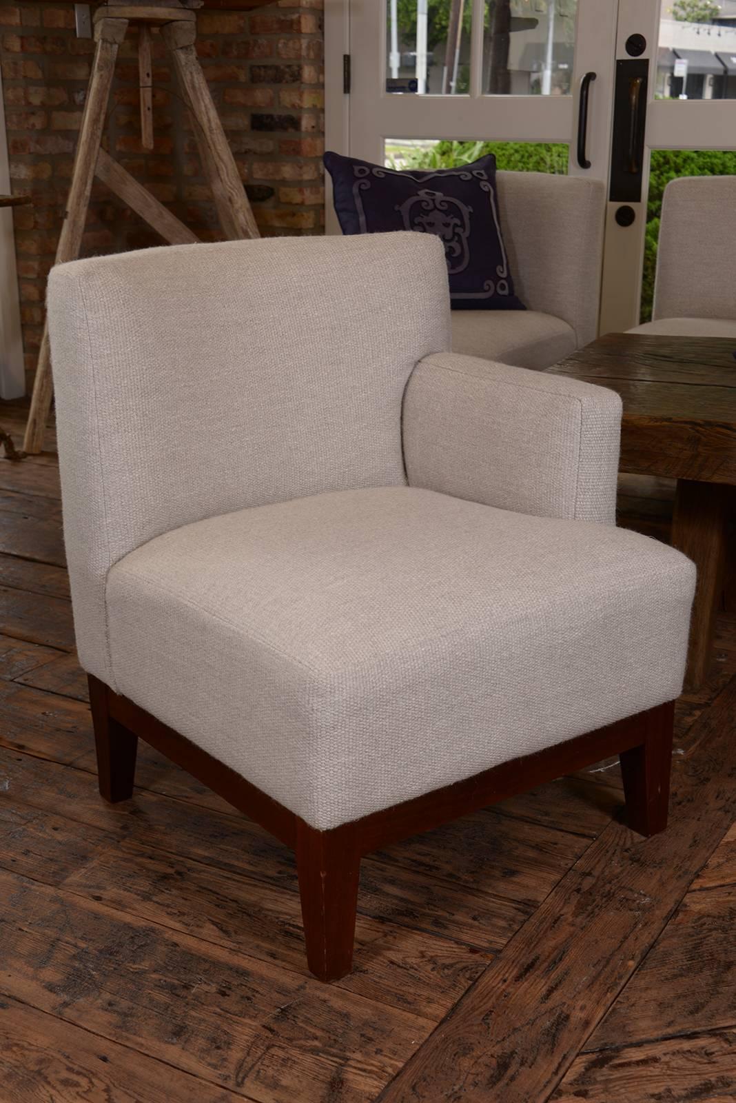 Very chic pair of club chairs with opposing arm on each side of the chairs. From a London hotel in the 1950s. Upholstered in a gorgeous Rosemary Hallgarten double weave fabric.
Sold as pairs, and we have several available.