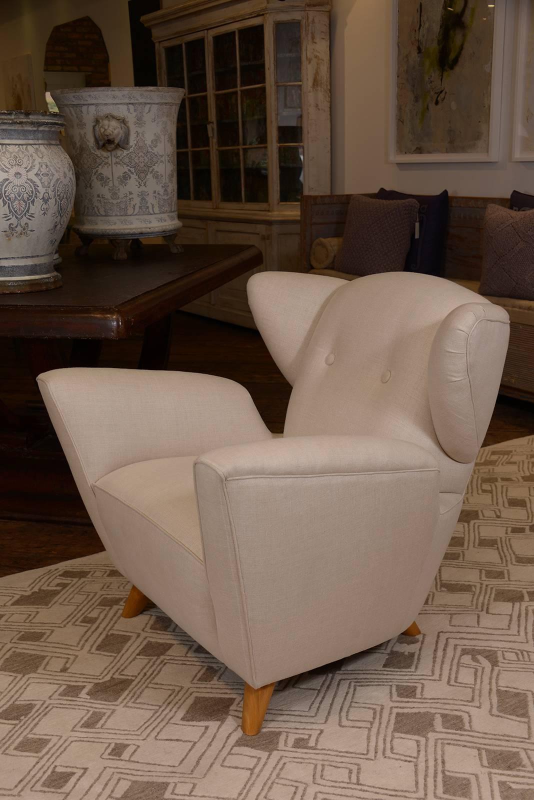 This is an M. Naeve custom Mid-Century style winged chair. Clients must provide their own fabric. 8 yards to cover.