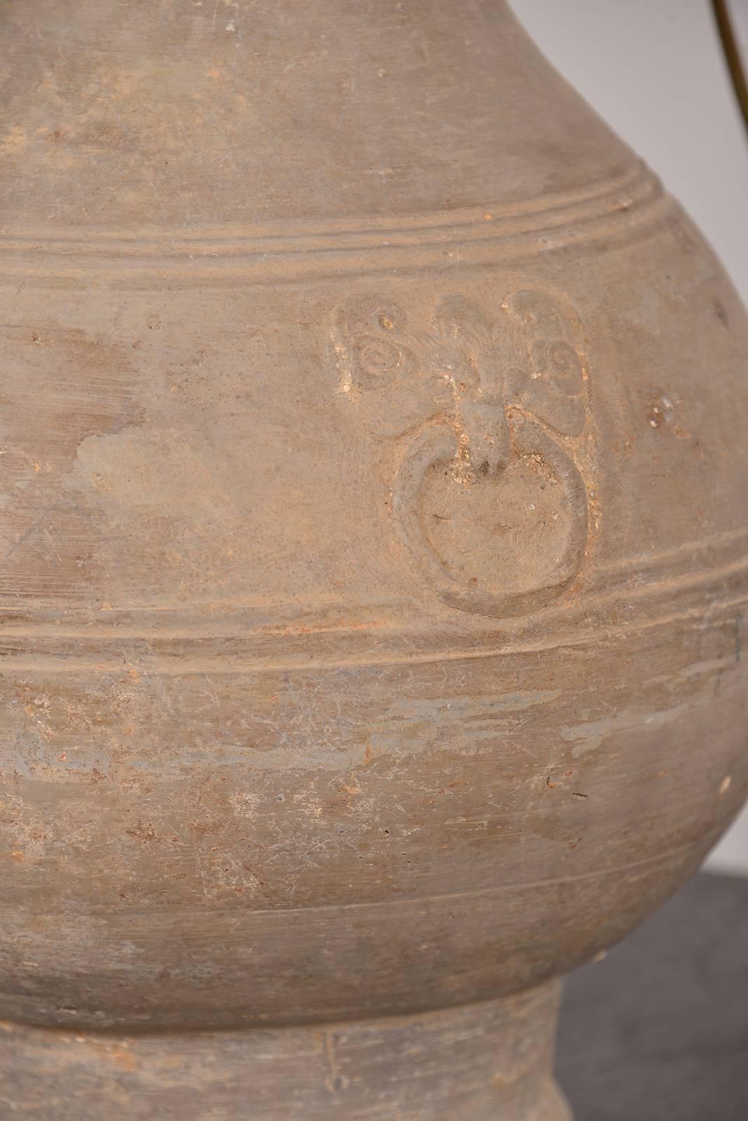 A Chinese Han dynasty unglazed terracotta jar, 