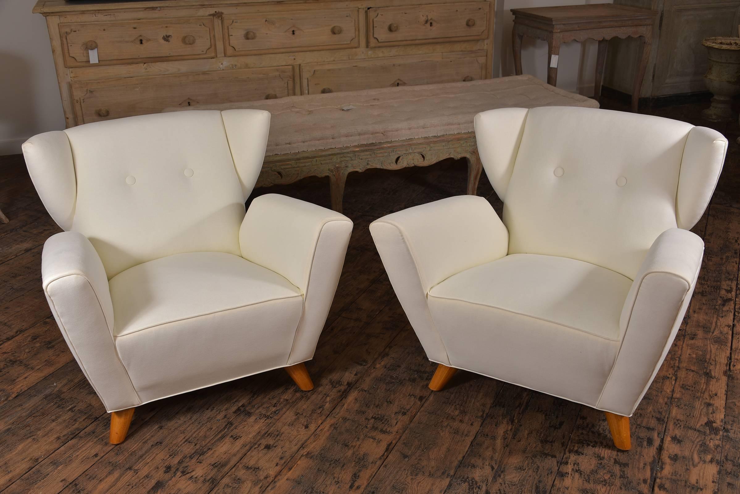 Very unusual pair of Italian wing chairs, circa 1950 made by Umberto Nordio. Complete with new upholstery by Holland and Sherry. A very comfortable pair of chairs.
 