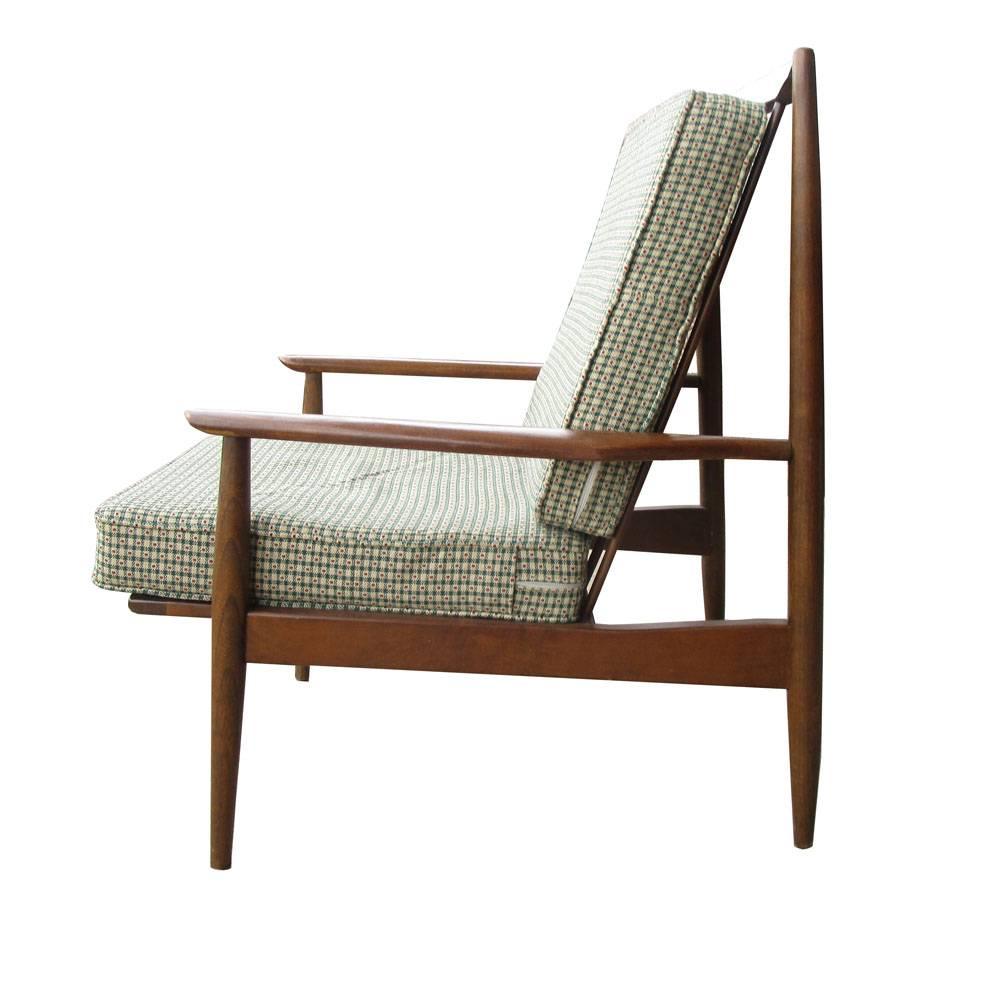 Scandinavian lounge chair
 
 Solid teak with off-white cushions.
This Danish teak lounge chair is supported by a slat-back and rubber seat straps, 

Measures: 22" W x 34" D x 37" H.
Seat Height 21.5.