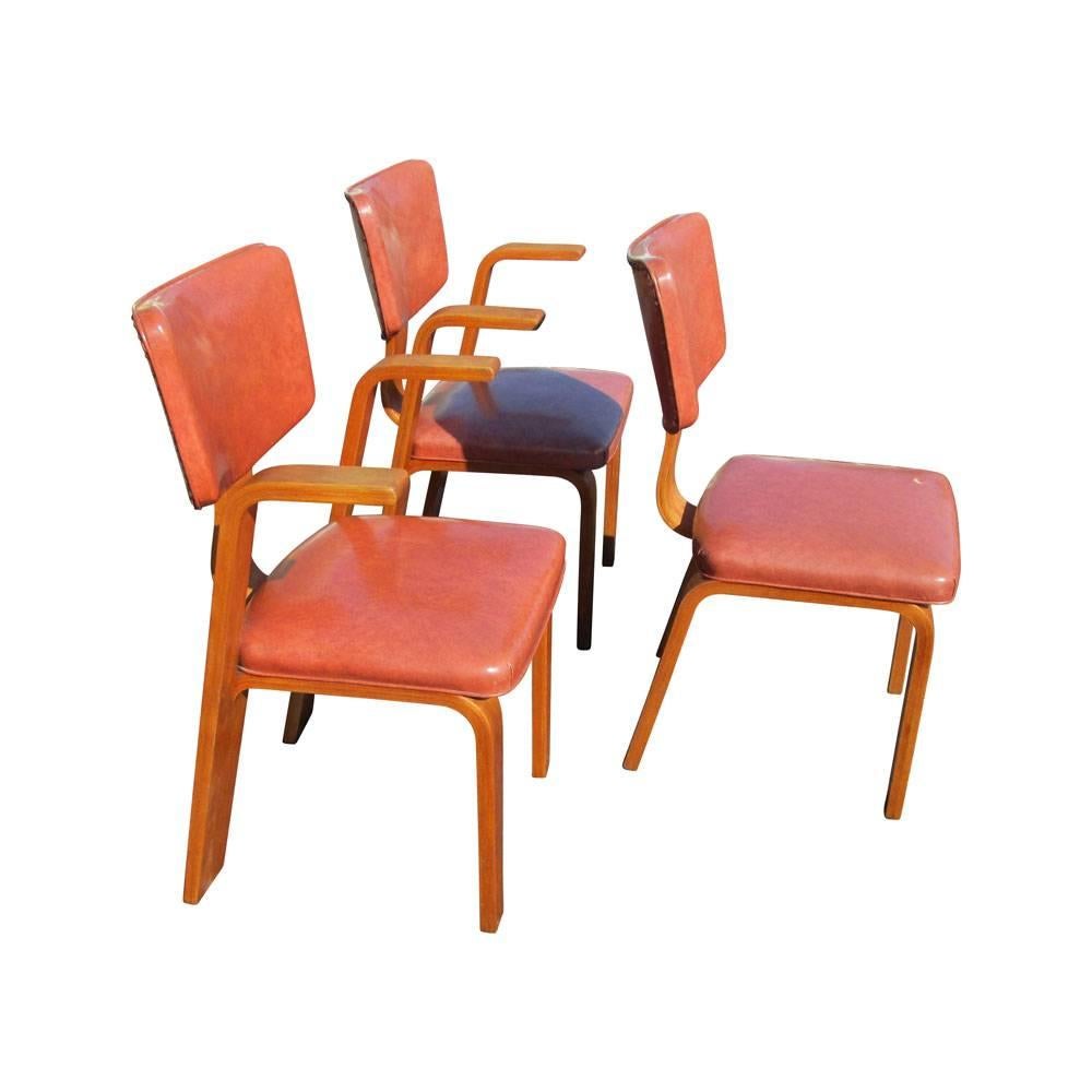 Three Joe Atkinson for Thonet dining chairs, circa late 1950s.
Frames are steam bentwood maple with slightly darker lacquer finish 
two with arms and one side.
Coppertone vinyl upholstery.
