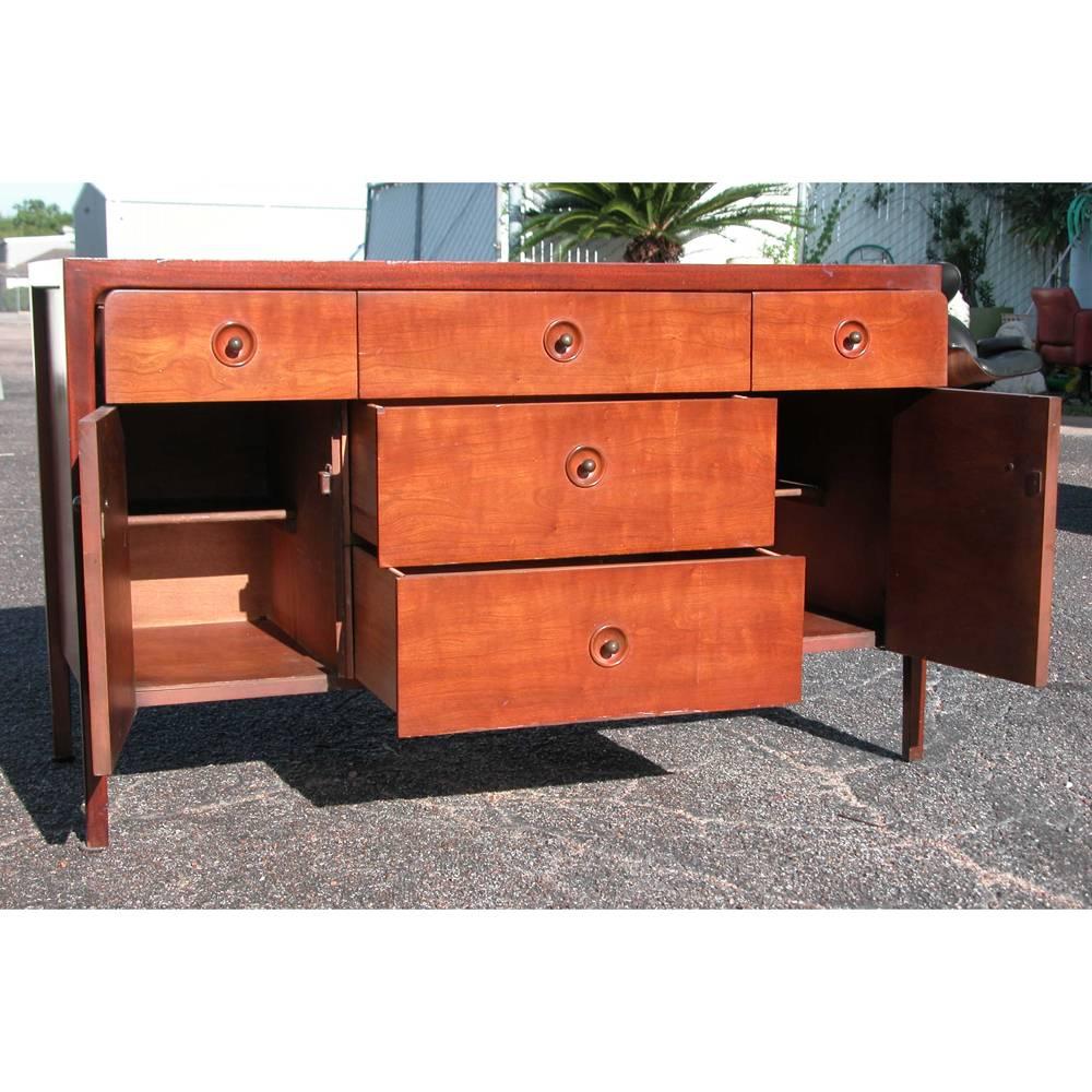 Classically elegant, this Mid-Century Modern Drexel counterpoint piece can be used as a credenza or dresser; with six deep drawers of ample storage and behind double doors more storage. Drawer pulls are recessed with small patina
