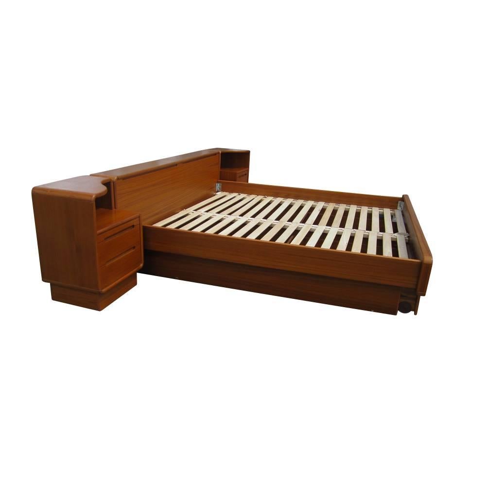 Vintage Mid-Century Modern Danish teak platform bed all teak construction two nightstands attached nightstands with two drawers and two recessed pulls each pull-out under bed storage. Measures: 125