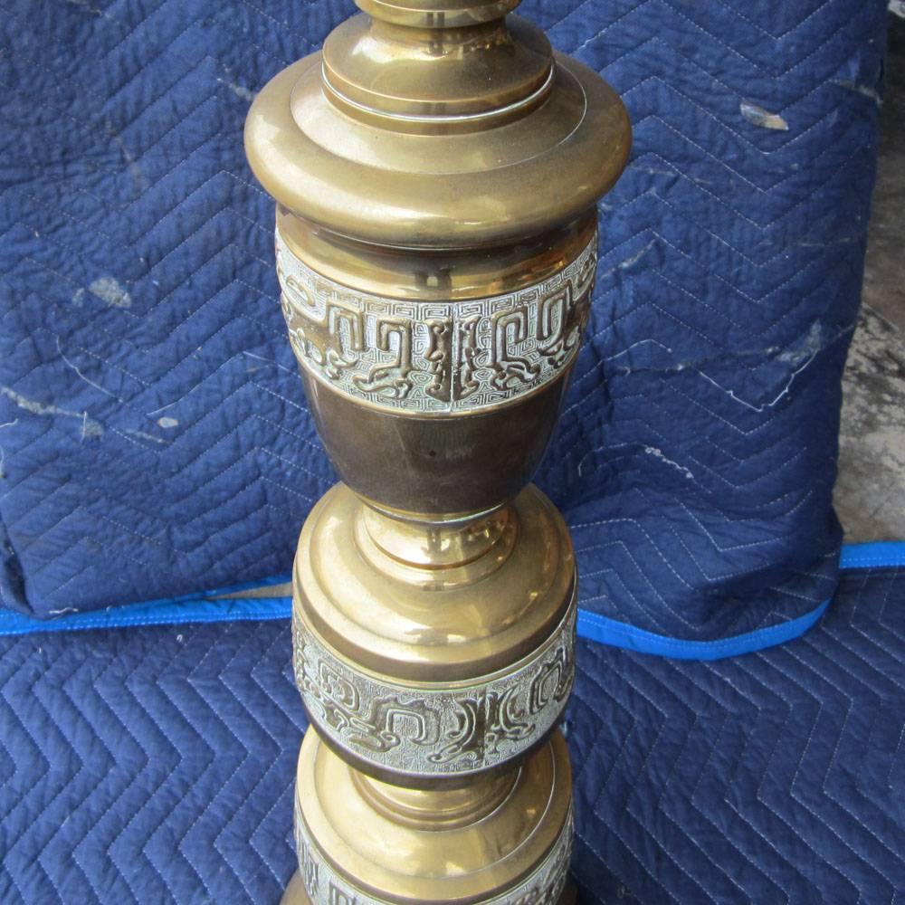 Pair of vintage brass candlesticks that have been converted into lamps. These lamps are decorated with a Greek geometric motif and interesting eastern characters.