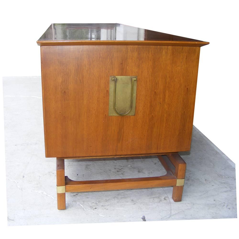 Vintage Mid-Century credenza buffet
 
1960s design with brass pulls and embellishments on sides and base
Butternut finish with double cabinet doors 
Flatware drawers on each side
 
There is a matching side or nightstand available.