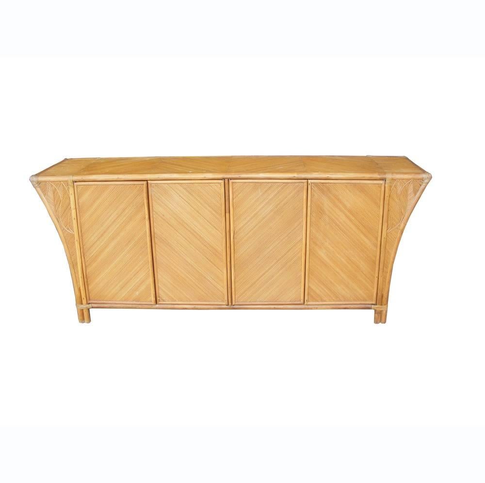 Vintage Baughman style bamboo credenza cabinet 

Honey finish with leaf details 

Two cabinets open to ample shelving

Measures: 72