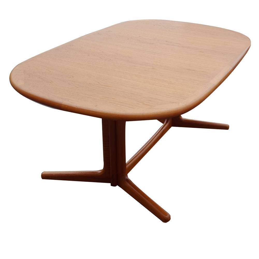 A Mid-Century Modern dining table designed by Gudme Møbilfabrik. Teak construction with two leaves that expand the table from 61