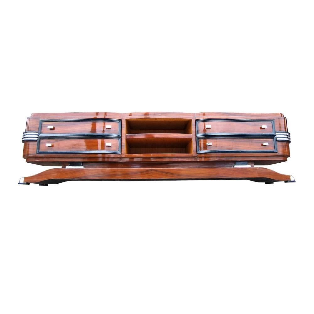 Art Deco style burl pedestal credenza. Features four drawers and two shelves. Chrome pulls and ebony accents. This elegant piece would be a great addition to any space.