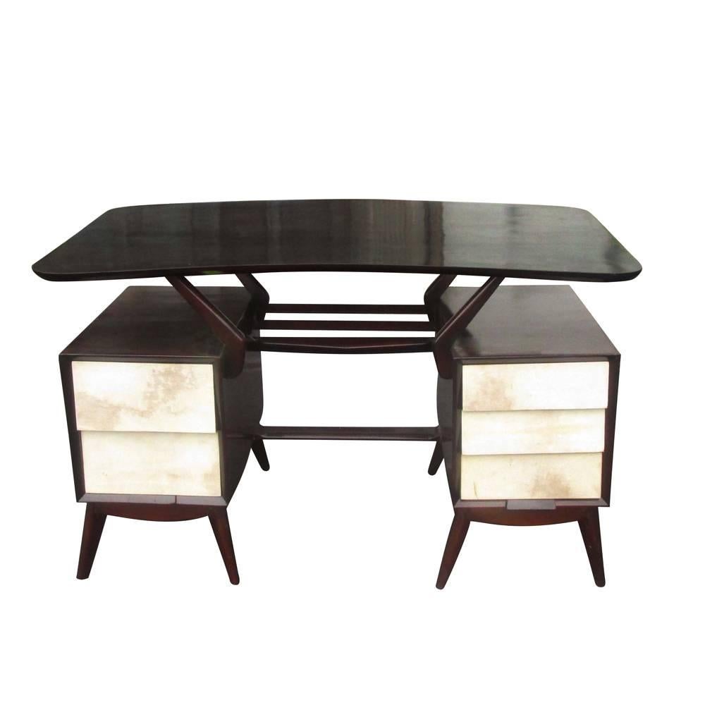 A vintage ebonized Italian desk with goatskin parchment drawers. This desk has a kidney-shaped top floating over two desk pedestals with splayed legs.
 