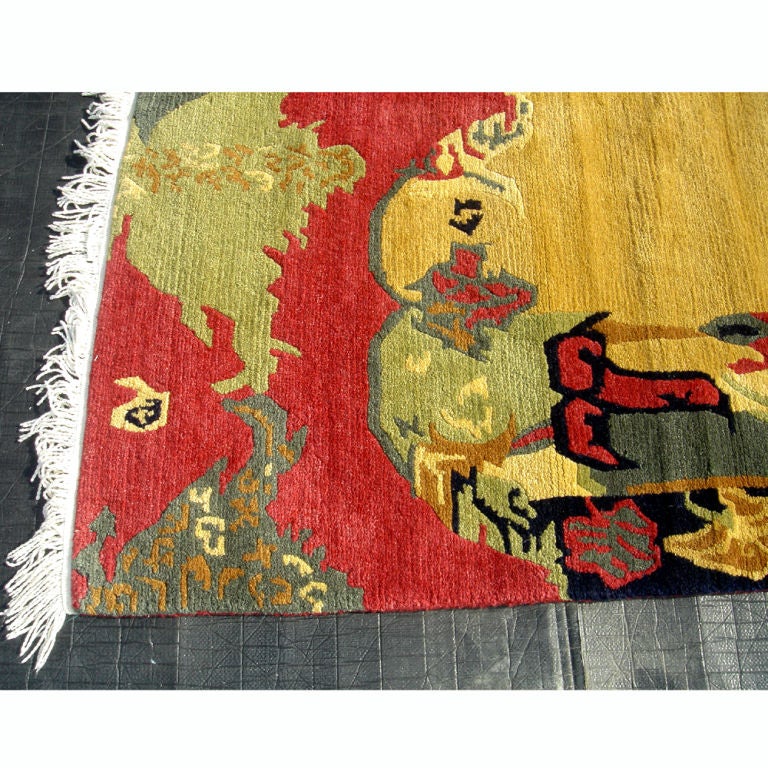 Colorful handmade rug with floral designs from Nepal.  Made from hand-knotted wool with fringe.