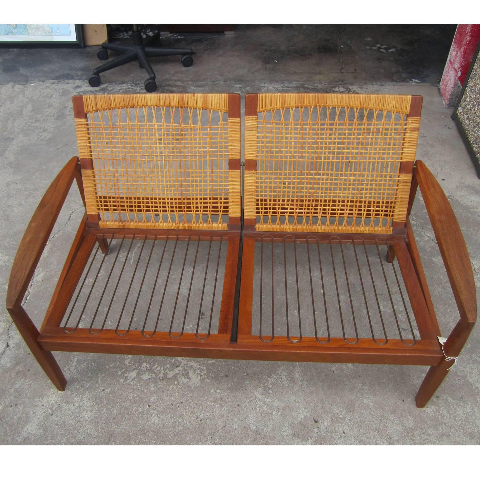 Vintage mid century Hans Olsen Settee 
Two-seater made from teak with can/wicker back 
Can be used with or without cushion for the back 
15 inch; Seat Height 
19.5 inch Arm Height