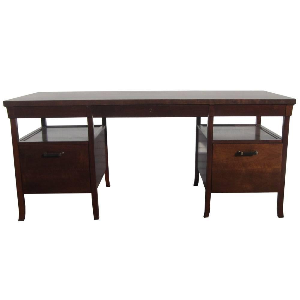 Vintage Bridger library desk by BILL SOFIELD for Baker 
1 box drawer with pencil tray, 2 drawers, center ledger drawer, and 1 file drawer 
Crafted in rich American walnut solids and plank-matched veneers; Rubbed Bronze and Basalt pulls 