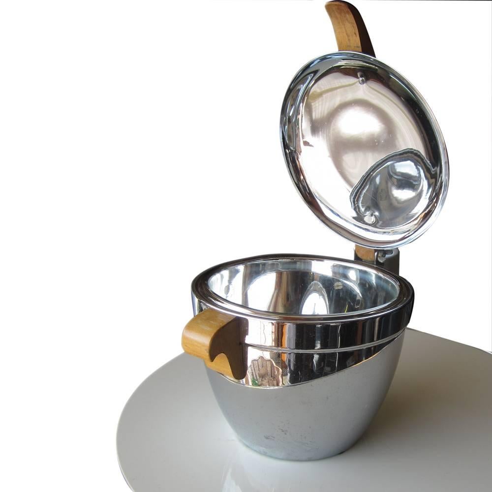 Vintage Art Deco Wood Chrome Ice Bucket
1930s
 
Chromed bucket form with maple lift handles and lid handle. The lid handle spanning the domed lid aligning at the lift handles on either side.