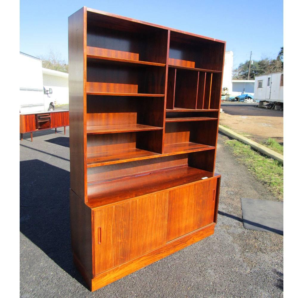 Vintage Rosewood book case / wall unit by Poul Hundevad 
Top unit has open shelves, bottom unit has adjustable shelves inside sliding doors cabinet. All in rosewood. 
Made in Denmark

54