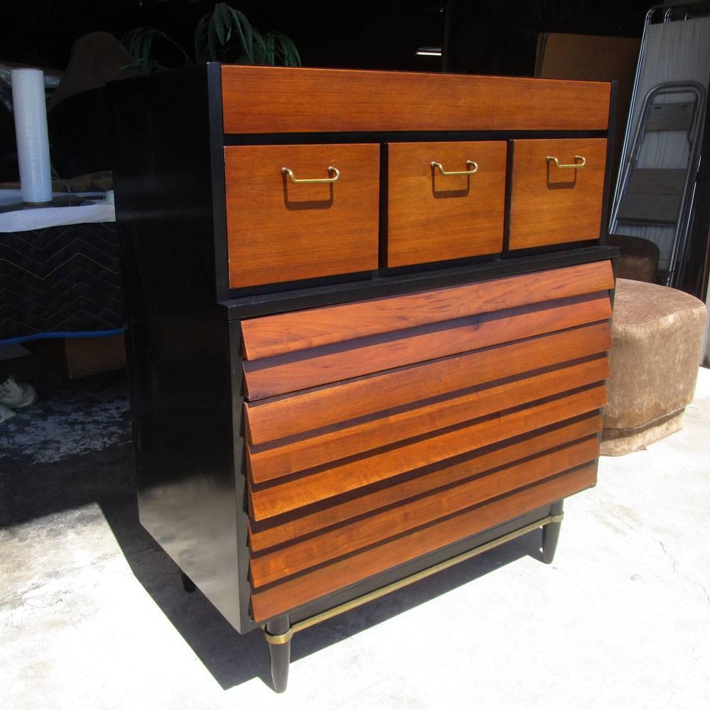 Vintage Mid century modern American of Martinsville high boy dresser. 
In its charming form made of solid walnut with black lacquer. The dresser has three louvred slats drawers lower and three brass-handled drawers upper. 
Originated from Dania