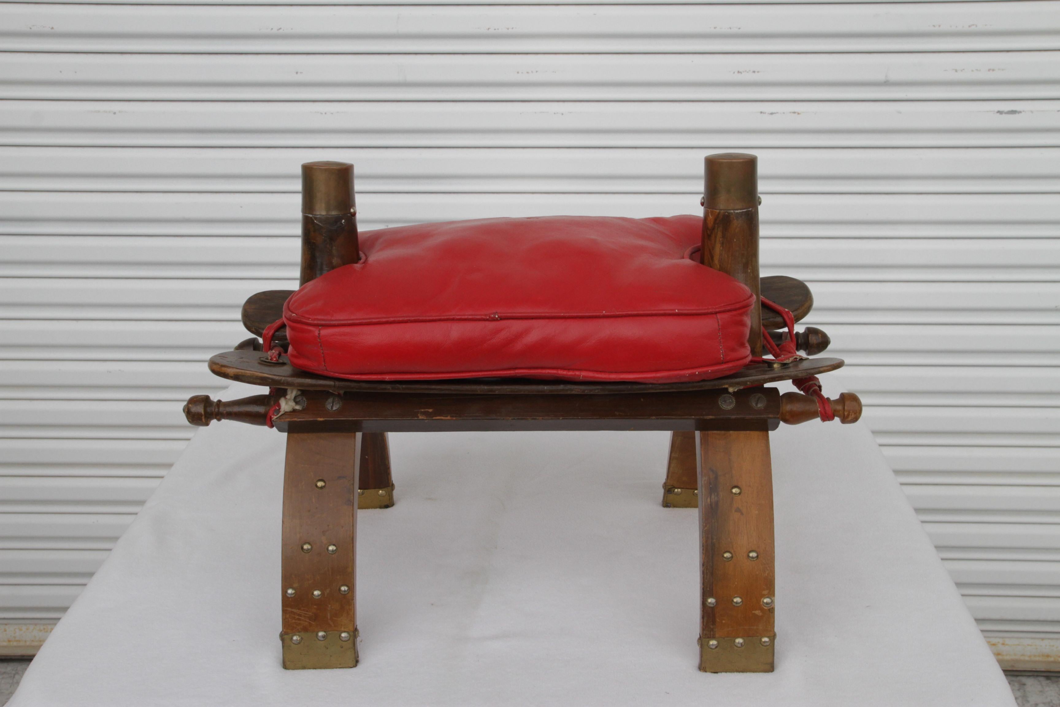 1950s Moroccan camel stool with original vintage red leather cushion.
Dimensions: 
Length: 12.25