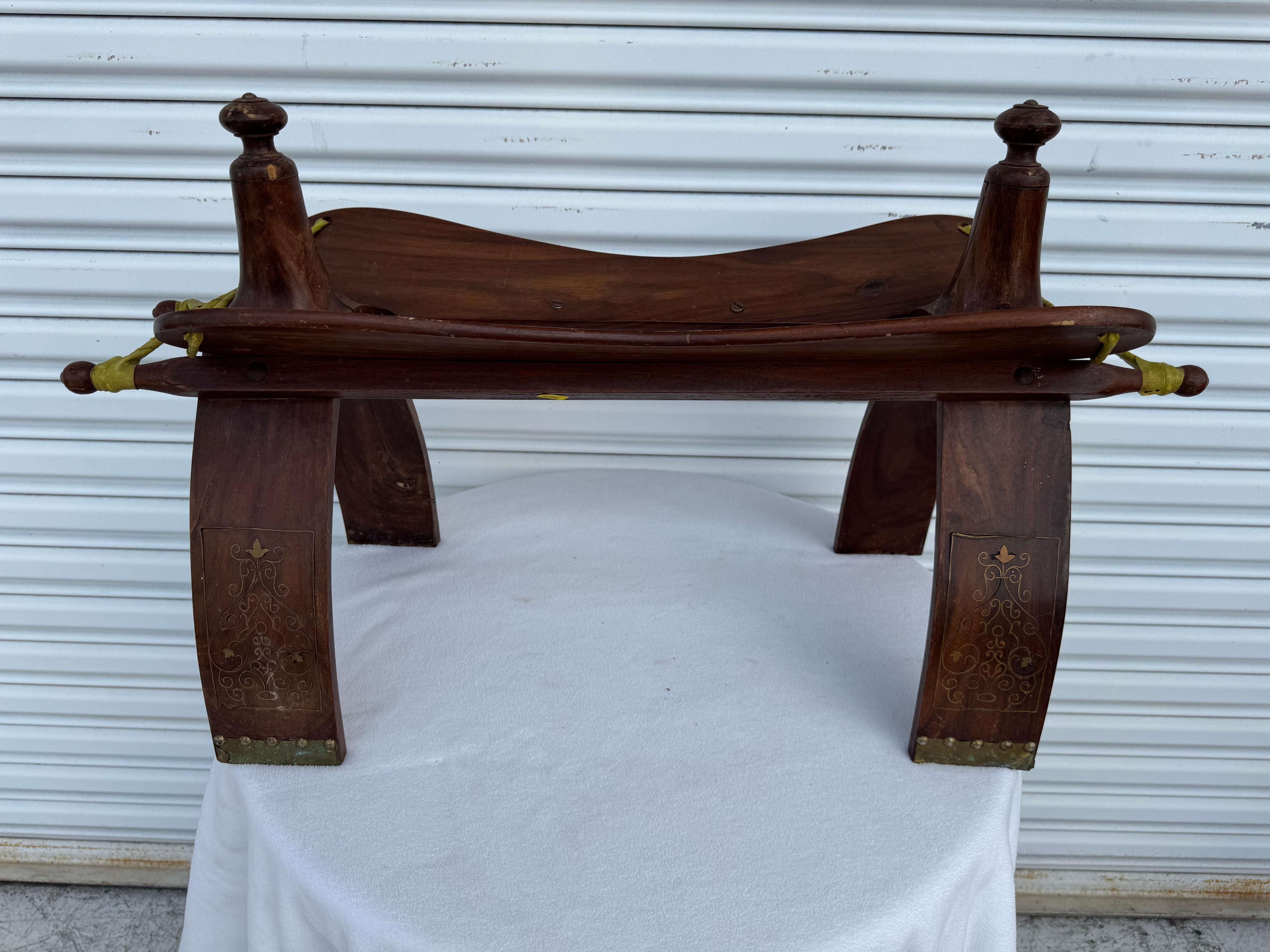 Vintage Egyptian, North Africa camel saddle shape stool.
Traditionally used to ride camels in the desert of Africa and the Middle East, this camel saddle could be used as a foot stool or just as an accent tribal piece in any room. Middle Eastern