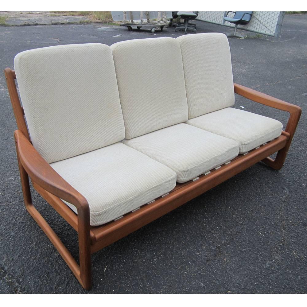 Vintage Danish three-seat sofa 
Solid teak with off-white cushions made by Juul Kristiansen 

74.5