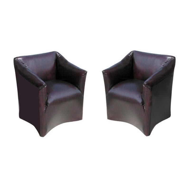 Pair of Mario Bellini Tentazione 685 Armchairs 
1973   

 Fully insured molded soft contour form (polyurethane foam and polyester padding).
Frame: steel construction on casters.
Newly reupholstered in oxblood leather.

Tentazione means temptation an