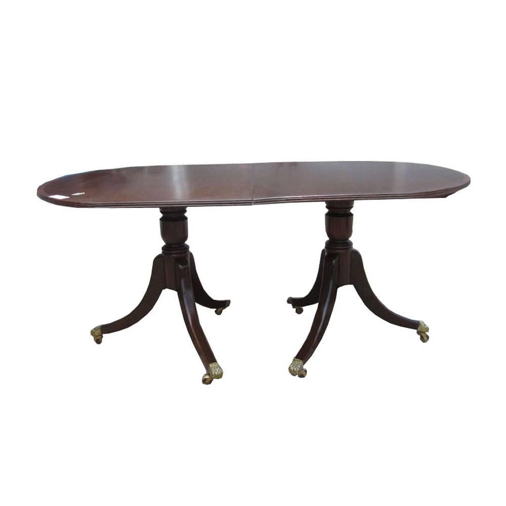 Grace and function combine in this elegant vintage rosewood extending dining table. This table extends using a leaf to accommodate guests or display a buffet requiring an ample display space. This dining table can add a touch of sophistication to