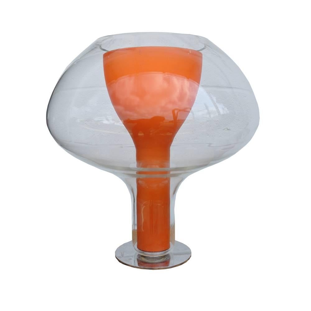 George Kovacs.

Karim Rashid.
 

A George Kovacs glass table lamp. This lamp has an inner lampshade tinted orange and sits on a chrome base. The elegant shape of this lamp is ultra-modern, but with a touch of quirkiness. This is a lamp that would