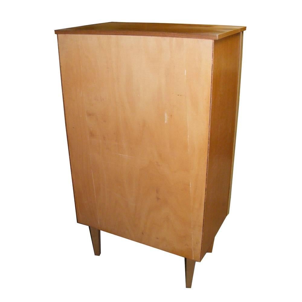 A Mid-Century Modern chest of drawers featuring Danish modern styling in teak with six drawers.