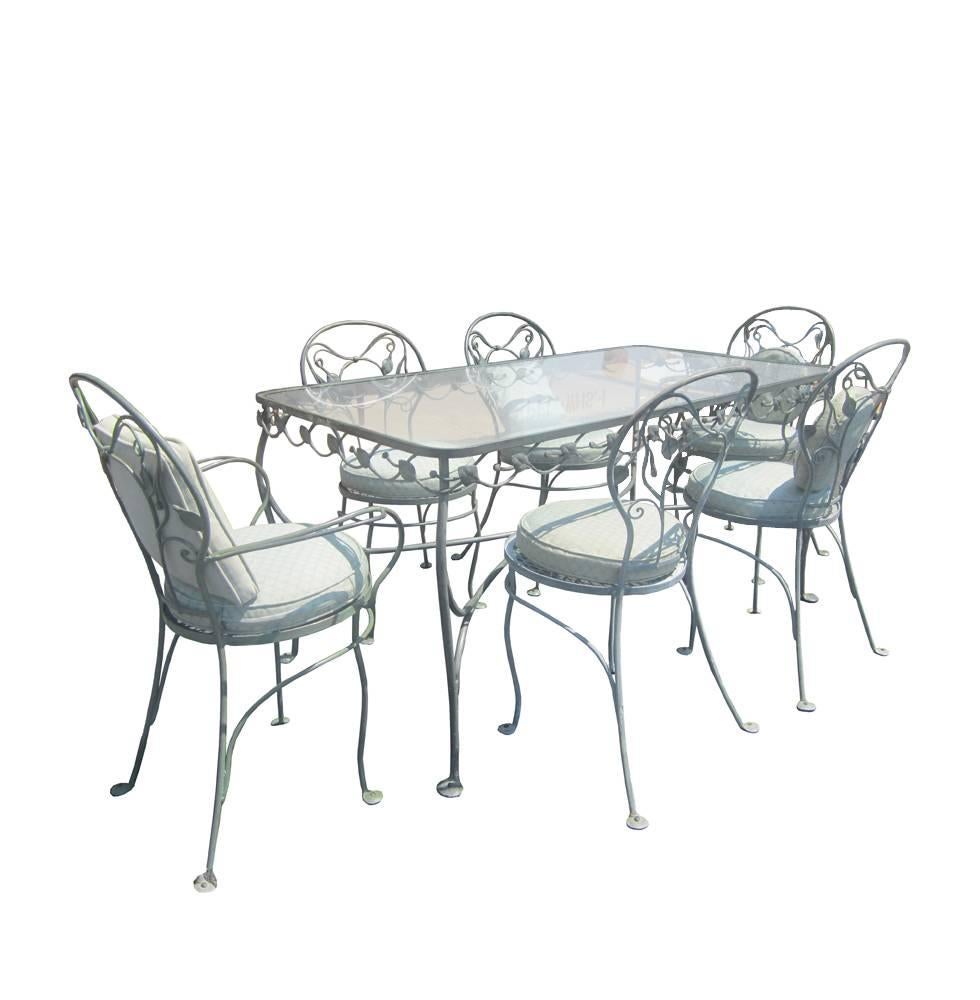 A set of eight vintage Salterini wrought iron patio chairs with a leaf motif and seat cushions. See wrought iron and glass dining table also by Salterini also available.

