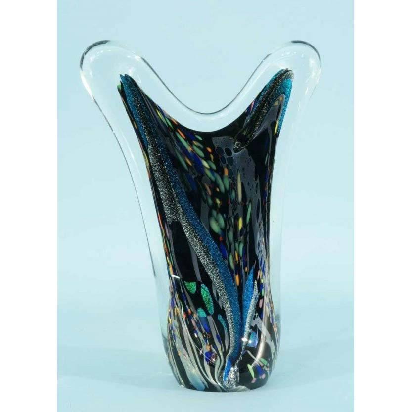 
Rollin Karg, is a renowned glass artisan from the Midwest who designs and creates small and massive sculptural pieces from molten glass, usually shaped in a freeform, asymmetrical manner. He brings the glass to life through his dynamic use of