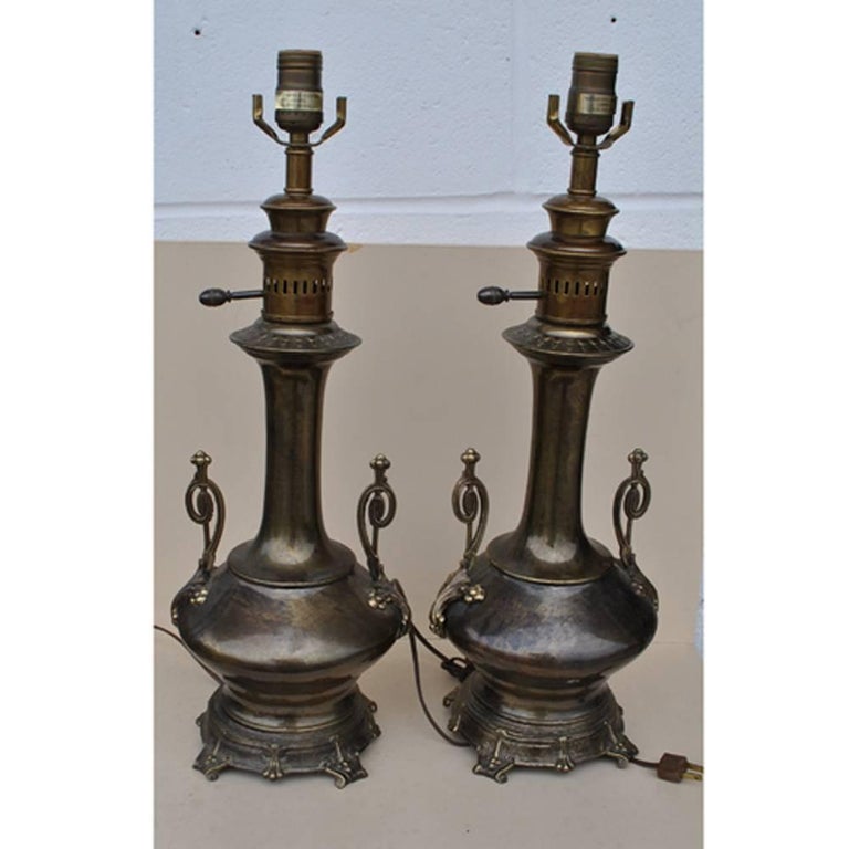 A vintage pair of aged brass lamps by Frederick Cooper 

A pair of urn style table lamps with intricate details and a beautiful patina on the brass.