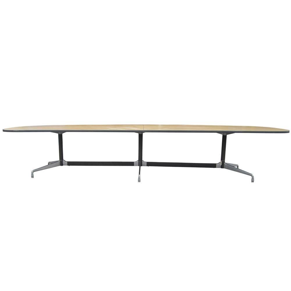 A vintage 12 foot conference table designed by Charles and Ray Eames for Herman Miller. This table features a laminate top with an aluminum base.