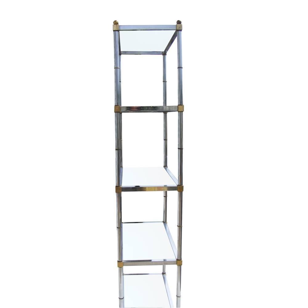 Attributed to Maison Jansen
 

Midcentury brass and chrome étagère in the manner of Maison Jansen 

Five shelves with chrome and brass faux bamboo details. Measures: 6ft.