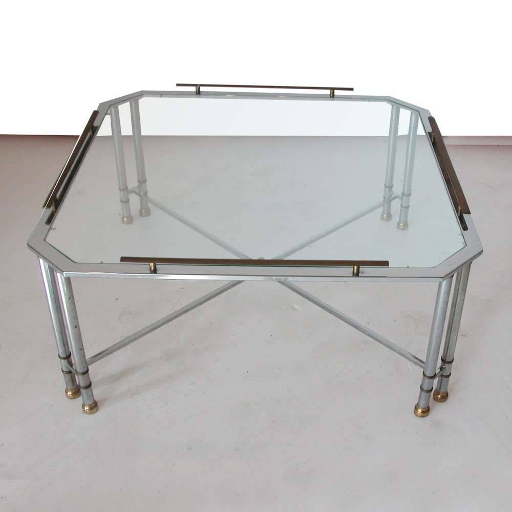 Chrome brass and glass octagon coffee table by Maison Jansen 

Mid-Century Modern octagon shaped coffee table in the style of Maison Jansen.
Neoclassical elements in brass and chrome.