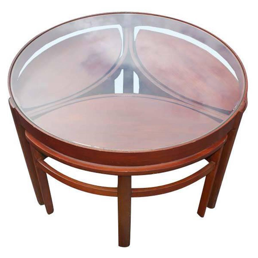 Vintage Danish wood glass nesting coffee side tables 

Four-piece set 

Teak and glass 
One circular glass top with wood base table
Three oval shaped wood nesting tables

Glass top table 
32.25