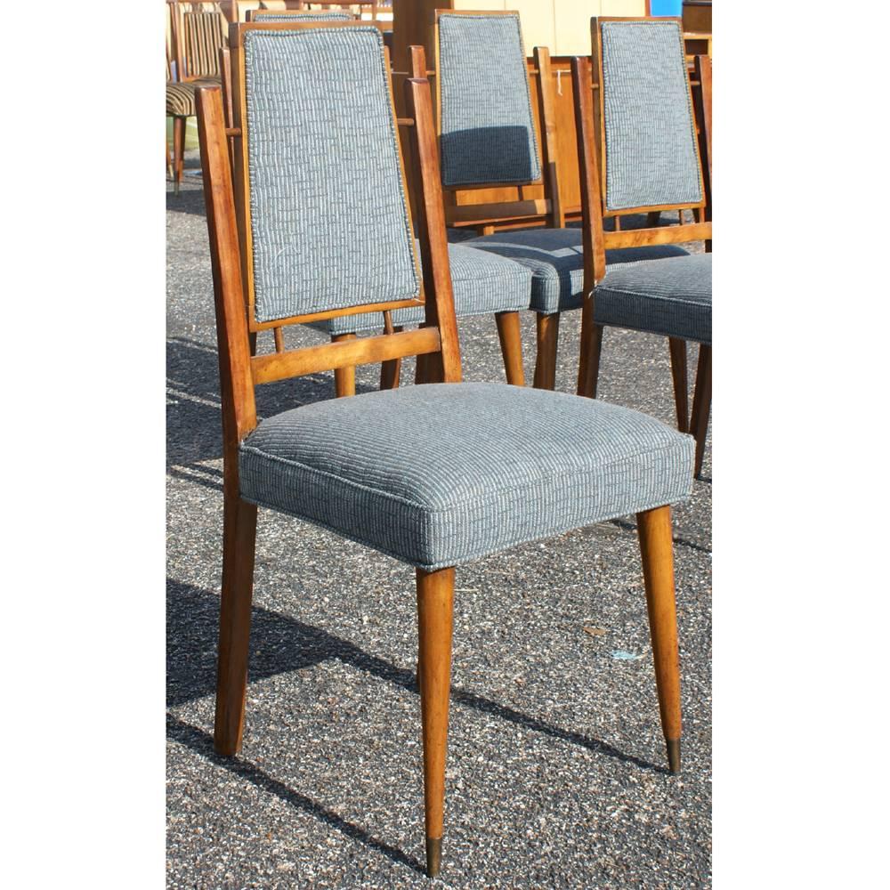 Walnut frame. 
Bronzed capped tapered wood legs. 
Featuring splayed leg design. 
Blue fabric upholstered seats and backs,
circa 1950s.
 