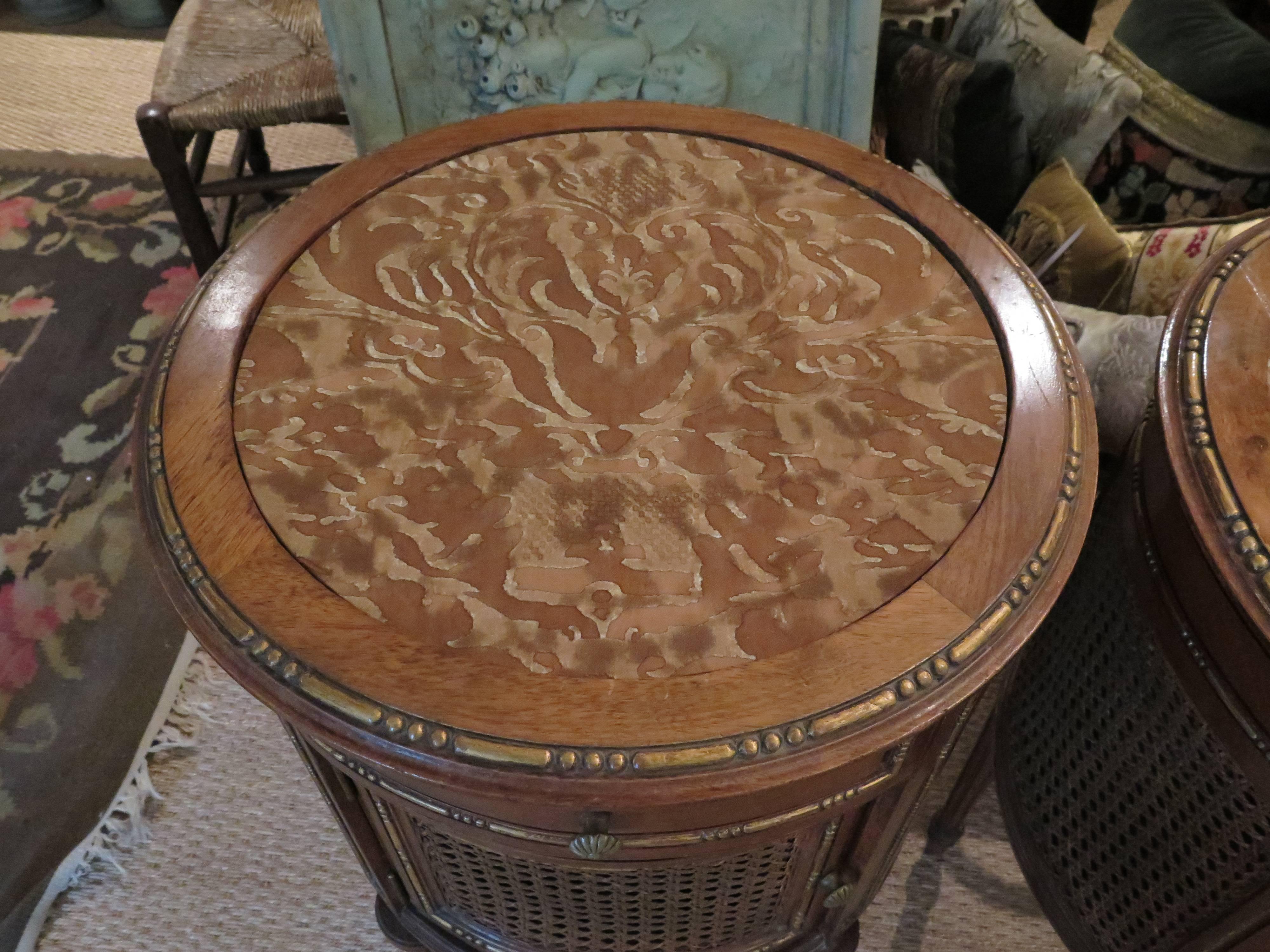 Louis XVI style parcel-gilt pair of end tables with beautiful carved parcel-gilt details and caning. Top is upholstered in Fortuny fabric. Nightstands come with glass tops that are not in most of the pictures due to reflection.