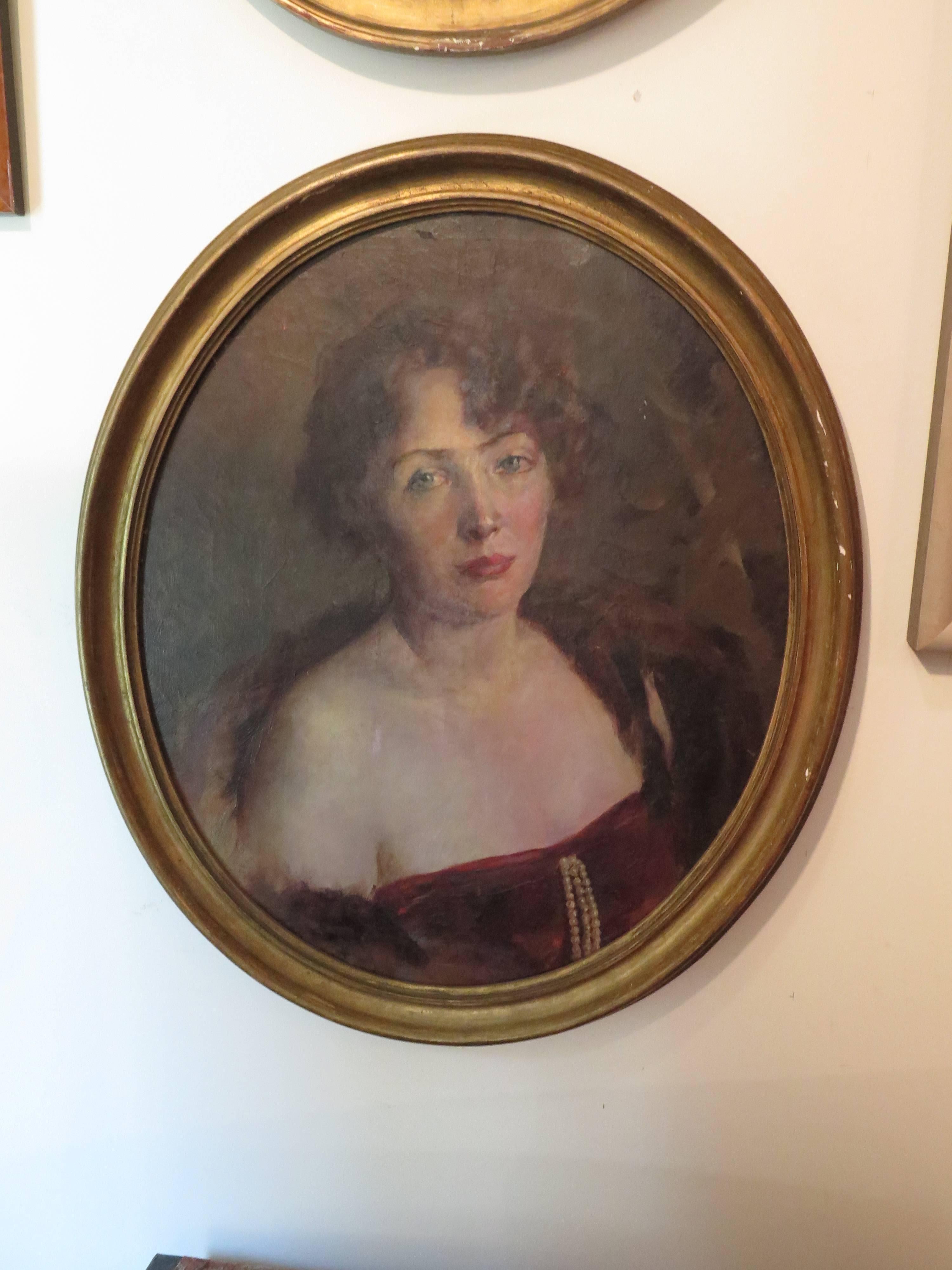 Large oval giltwood framed portrait of woman. This is an oil painting on canvas wrapped on to a board.