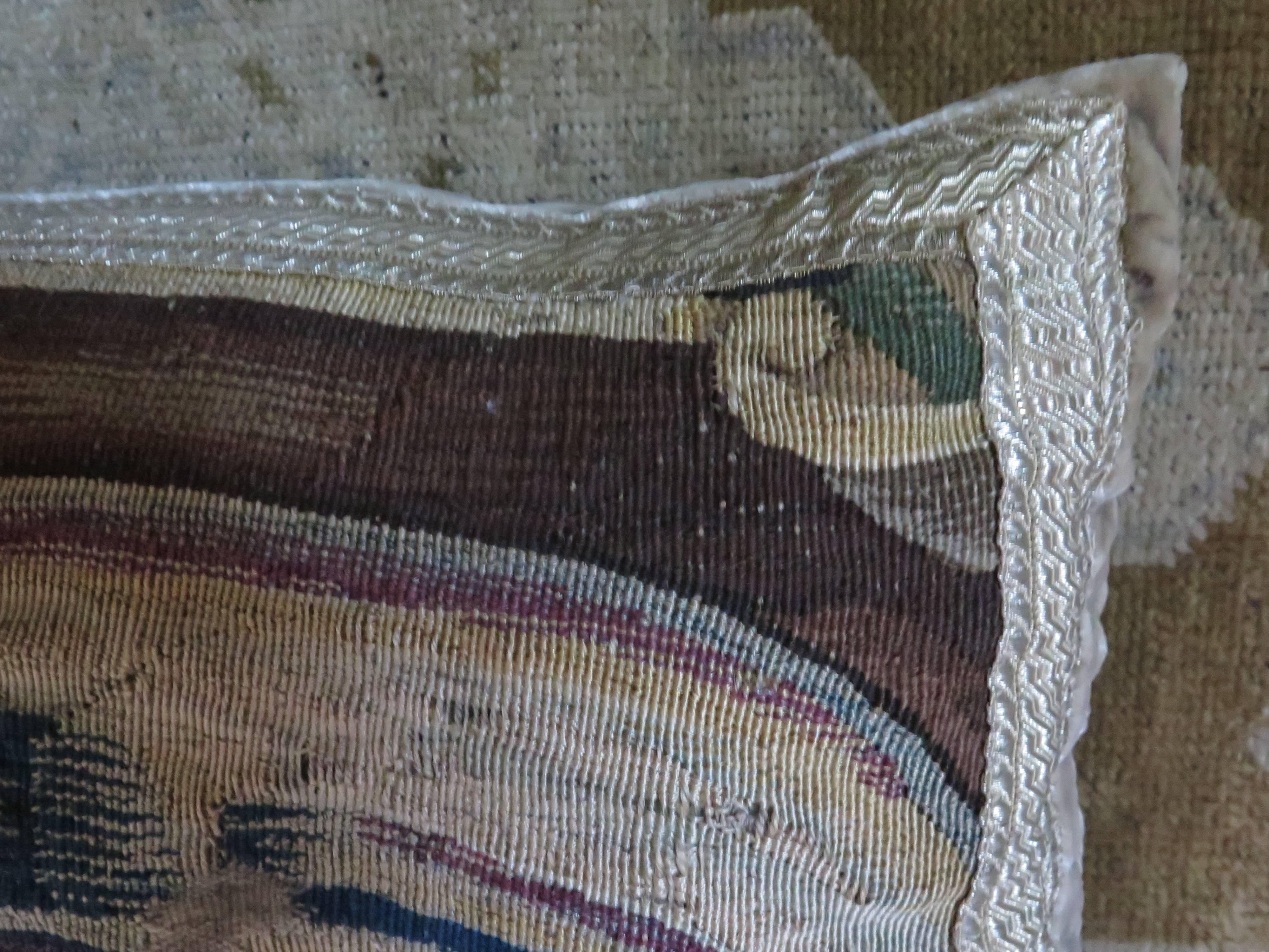 18th Century tapestry pillow with a silver/gold trim framing the tapestry fragment. Pillow is made of silver/gray silk velvet. Down filled.