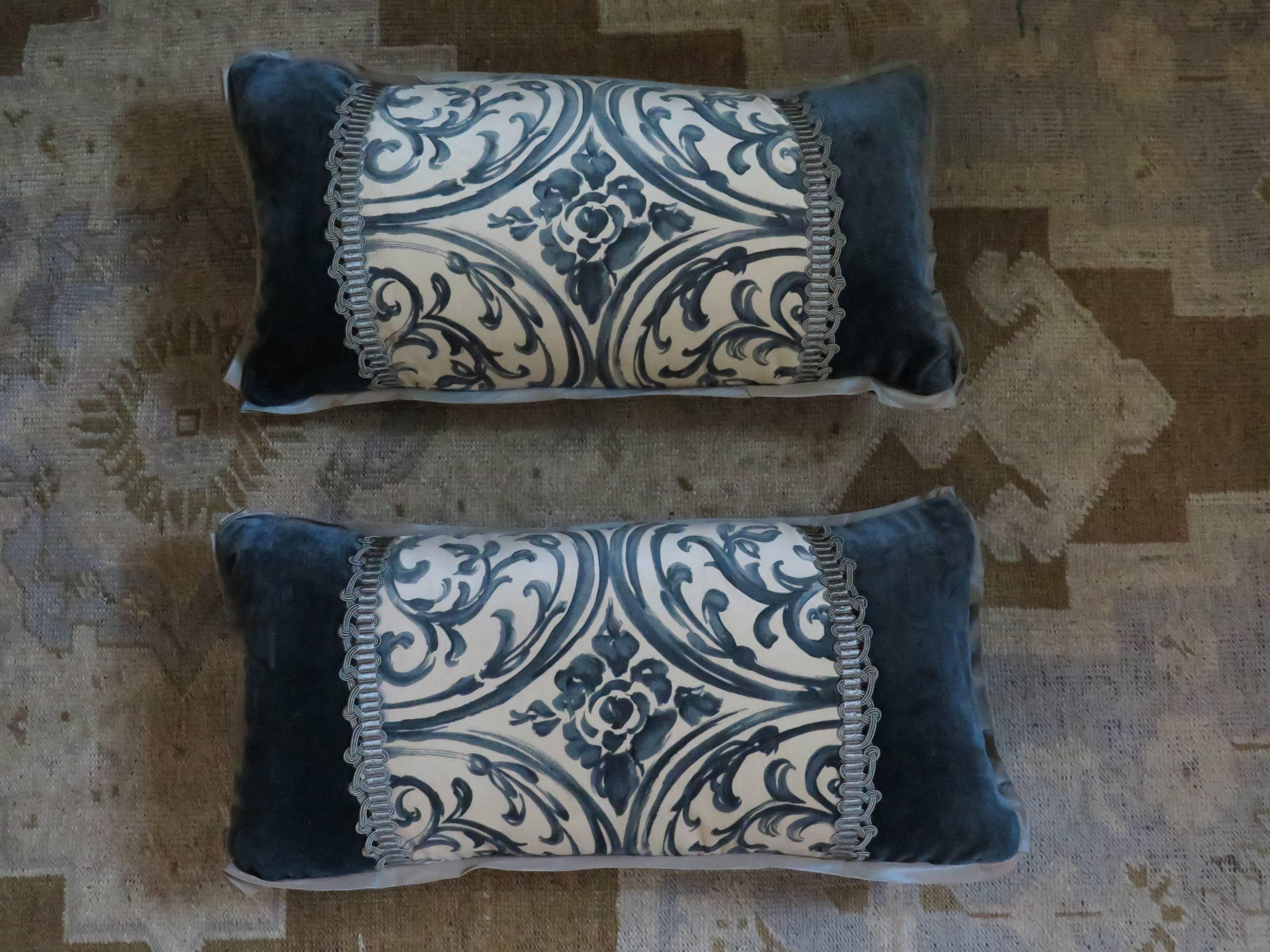 Beautiful pair of lumbar pillows with elegant design. Pillows are made of a rich teal silk velvet with a silk taffeta flange. Beautiful metallic trim frames vintage velvet fragment. Down filled.