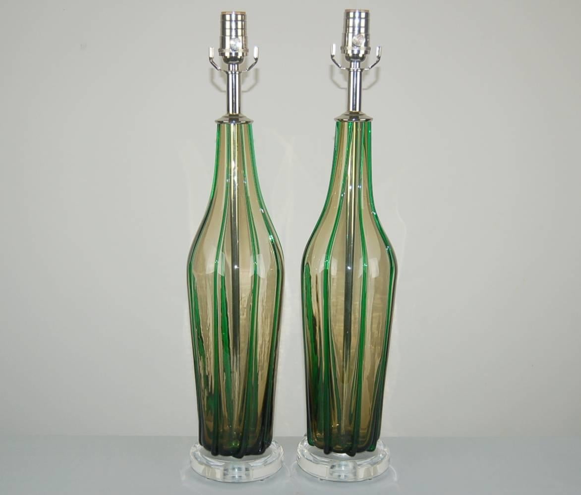 Vintage Murano table lamps in SMOKE, adorned with applied glass pin stripes of EMERALD GREEN. A matched pair, so rarely found 50 years after they were made. 

They stand 24 inches from tabletop to socket top. As shown, the top of shade is 30 inches