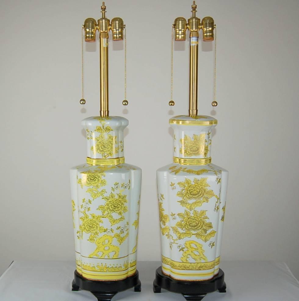 Beautiful pair of hand-painted Porcelain lamps imported by Marbro in 1969. Colors are canary yellow over white perfect condition. 

They stand 33 inches from tabletop to socket top. As shown, the top of shade is 35 inches high. Lampshades are for