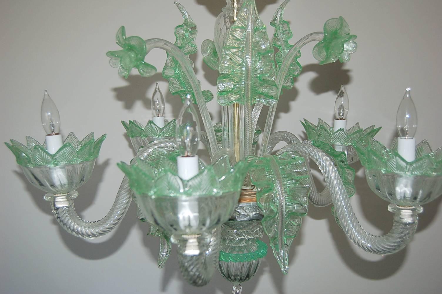 Very chic vintage five-light Murano glass chandelier, circa 1950s, made of Murano Crystal with green glass accents. Newly rewired and rebuilt. 

The chandelier is 25 inches in width, and 26 inches in height, from glass to glass.